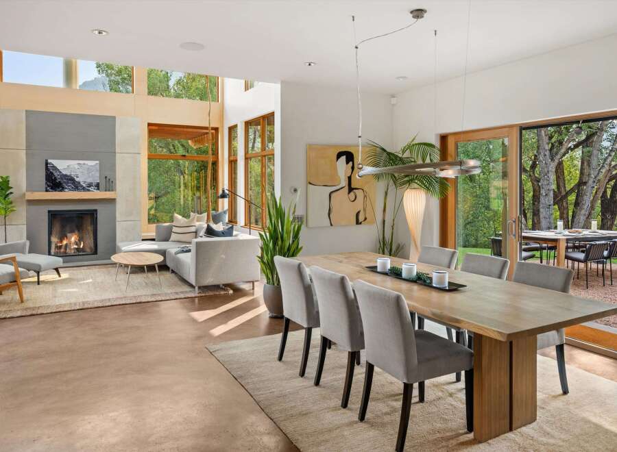 Experience modern living in this stunning open-concept home, featuring a cozy fireplace and expansive windows that flood the space with natural light.