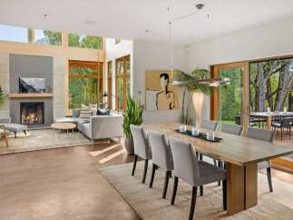 Experience modern living in this stunning open-concept home, featuring a cozy fireplace and expansive windows that flood the space with natural light.