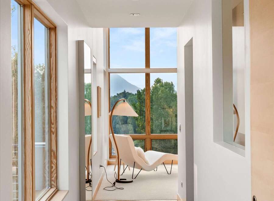 Experience breathtaking mountain views from this stunning hallway, featuring expansive windows that flood the space with natural light.