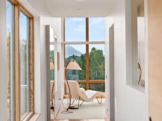 Experience breathtaking mountain views from this stunning hallway, featuring expansive windows that flood the space with natural light.