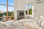Experience luxury living with breathtaking mountain and river views from this stunning bedroom.