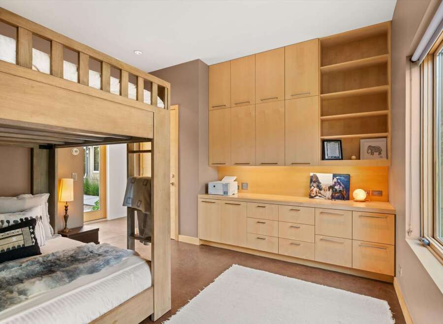 This bedroom features a charming wooden bunk bed, perfect for maximizing space and accommodating guests.