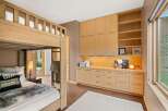 This bedroom features a charming wooden bunk bed, perfect for maximizing space and accommodating guests.