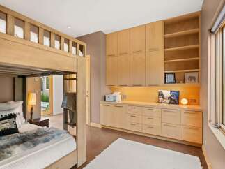 This bedroom features a charming wooden bunk bed, perfect for maximizing space and accommodating guests.