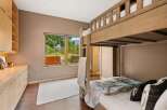 This charming bedroom features a rustic wooden bunk bed, perfect for accommodating guests or family.