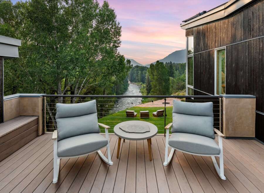 Experience breathtaking mountain and river views from this stunning modern deck, perfect for enjoying serene sunsets.