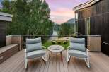 Experience breathtaking mountain and river views from this stunning modern deck, perfect for enjoying serene sunsets.