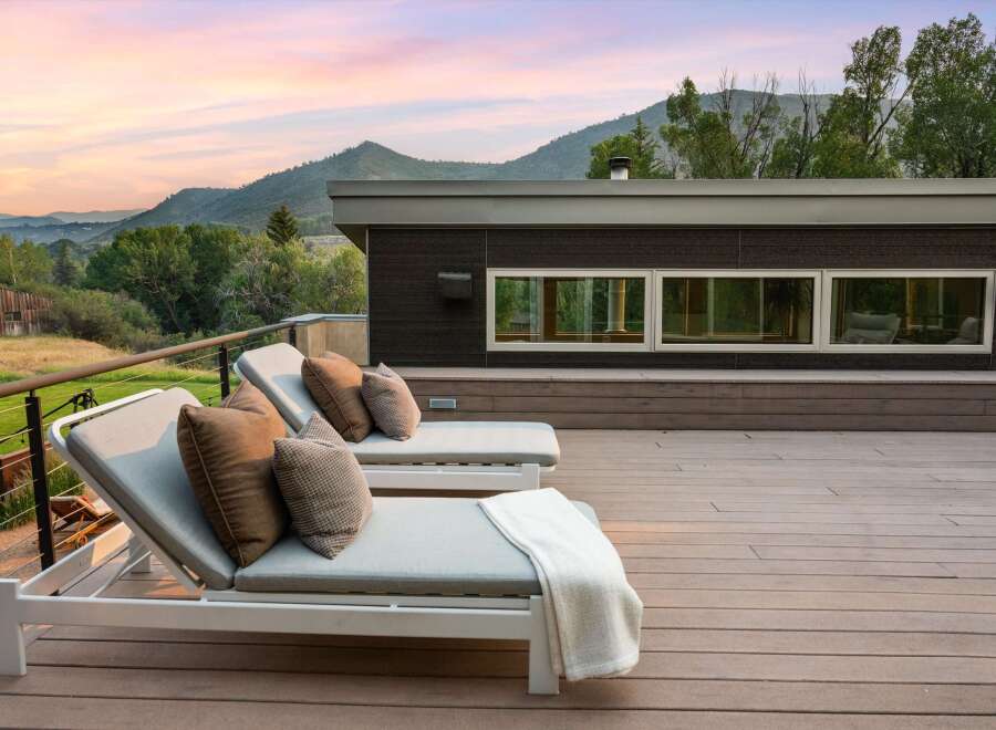 Experience breathtaking mountain views from this modern deck, perfect for relaxation and entertaining.