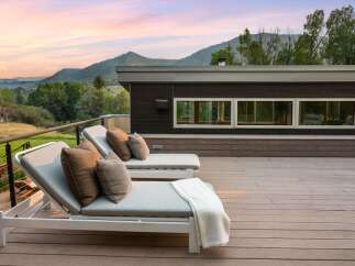 Experience breathtaking mountain views from this modern deck, perfect for relaxation and entertaining.