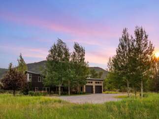 Experience the serene beauty of this modern mountain home, nestled amidst lush greenery and rolling hills.