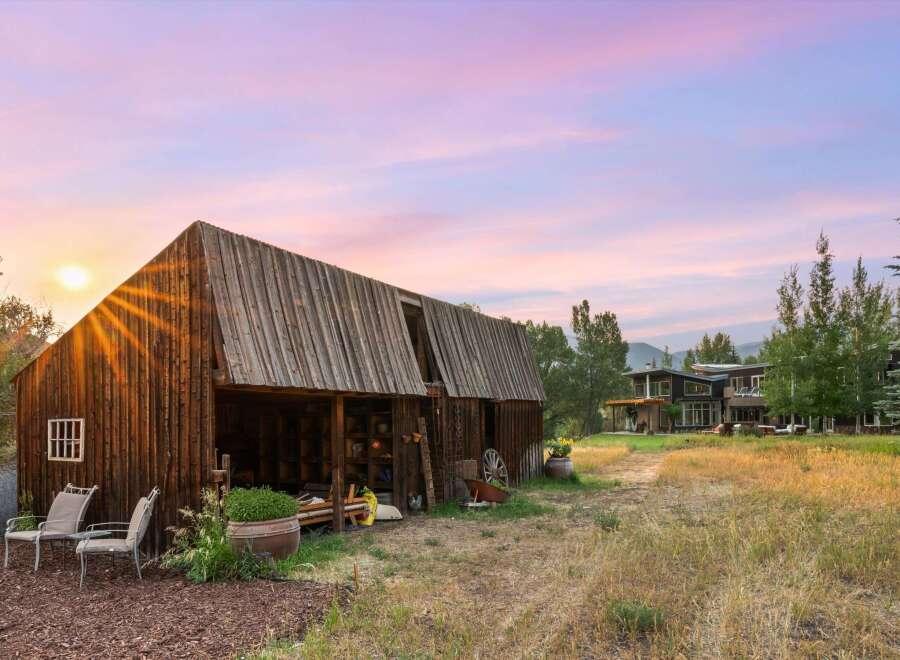 Experience rustic charm and modern luxury with this stunning property featuring a vintage barn and a contemporary home.