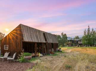 Experience rustic charm and modern luxury with this stunning property featuring a vintage barn and a contemporary home.