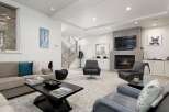 Experience modern luxury in this stunning living room, featuring a sleek fireplace and comfortable seating arrangements.