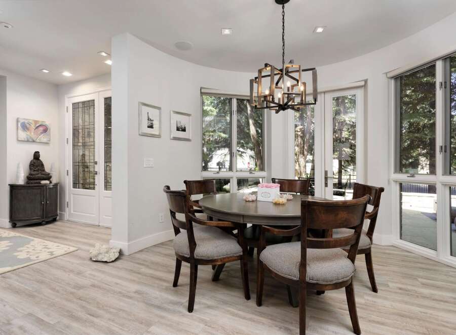 This dining room features a round, dark wood dining table with upholstered chairs, perfect for intimate gatherings.