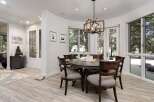 This dining room features a round, dark wood dining table with upholstered chairs, perfect for intimate gatherings.