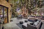 Experience luxurious outdoor living with this stunning patio featuring a modern gas fire pit and comfortable seating.
