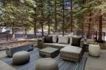 Enjoy outdoor living with this stylish patio featuring a modern gas fire pit and comfortable sectional seating.
