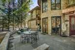 Experience luxurious outdoor living with this stunning patio featuring a round dining table and chairs, perfect for al fresco meals.