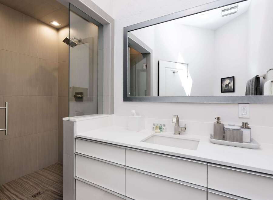 Experience modern luxury in this stunning bathroom featuring a spacious walk-in shower with elegant tile work and a sleek glass enclosure.