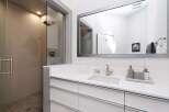 Experience modern luxury in this stunning bathroom featuring a spacious walk-in shower with elegant tile work and a sleek glass enclosure.
