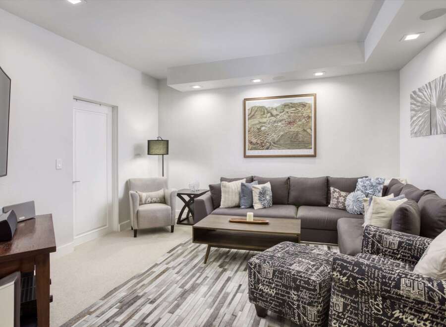 Experience ultimate comfort in this modern living room, featuring a spacious sectional sofa perfect for family gatherings.
