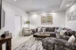 Experience ultimate comfort in this modern living room, featuring a spacious sectional sofa perfect for family gatherings.