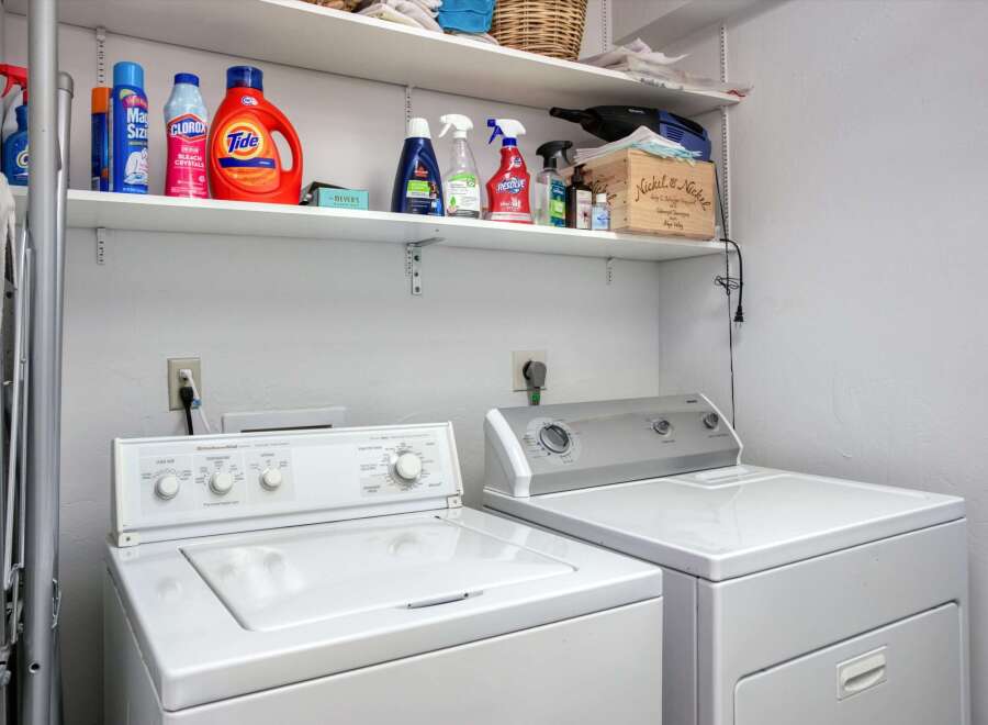 This laundry room features a stacked washer and dryer set, perfect for maximizing space in your home.