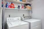 This laundry room features a stacked washer and dryer set, perfect for maximizing space in your home.