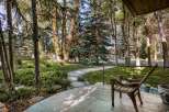 Step onto the inviting porch of this charming property, where a rustic wooden chair awaits.
