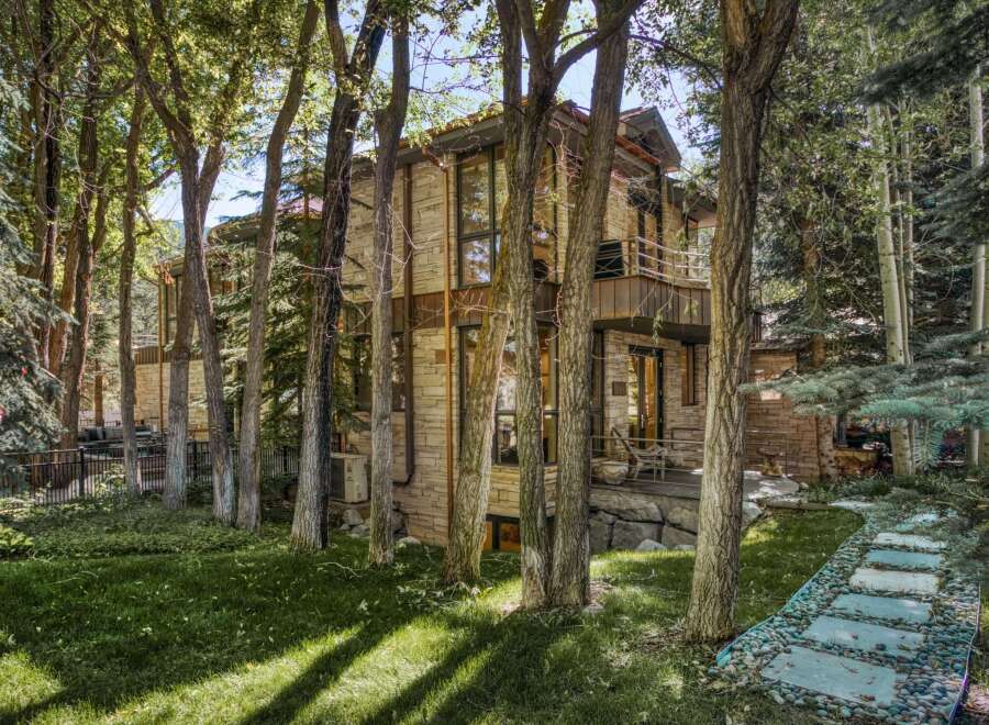 Nestled amidst lush greenery and mature trees, this stunning home offers a serene retreat.