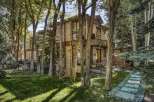 Nestled amidst lush greenery and mature trees, this stunning home offers a serene retreat.