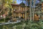 Nestled amidst lush greenery and mature trees, this stunning stone-clad residence offers a serene retreat.