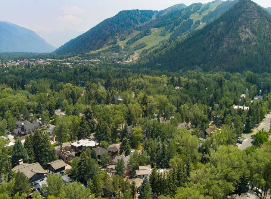 Nestled amidst lush greenery and towering trees, this stunning property offers a serene escape with breathtaking mountain views.