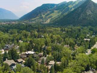 Nestled amidst lush greenery and towering trees, this stunning property offers a serene escape with breathtaking mountain views.