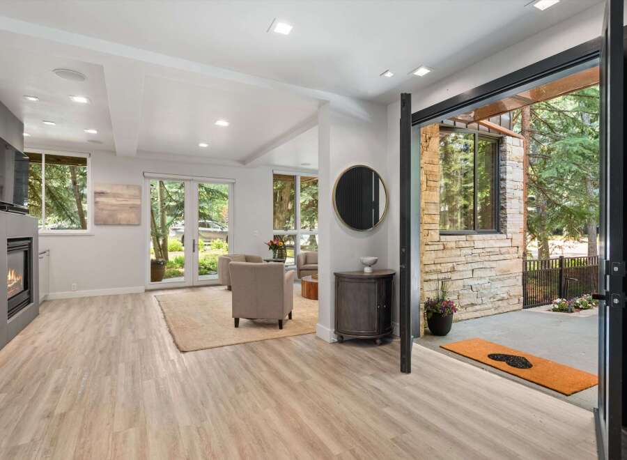 Step into this inviting living space featuring a modern fireplace and elegant hardwood floors.