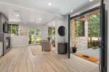 Step into this inviting living space featuring a modern fireplace and elegant hardwood floors.