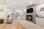 Experience modern living in this spacious open-concept home, featuring a sleek gas fireplace as the centerpiece of the living area.