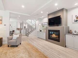 Experience modern living in this spacious open-concept home, featuring a sleek gas fireplace as the centerpiece of the living area.