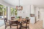Experience elegant dining with this beautifully set round table, featuring dark wood chairs with upholstered seats.