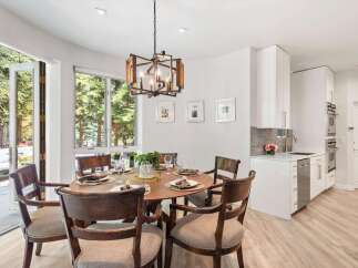 Experience elegant dining with this beautifully set round table, featuring dark wood chairs with upholstered seats.