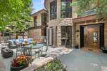 Experience luxurious outdoor living with this stunning patio featuring a comfortable sectional sofa, dining set, and a modern fire pit.