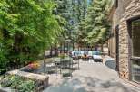 Enjoy outdoor living in this stunning patio space, featuring a comfortable sectional sofa, a dining set, and a gas heater for cooler evenings.
