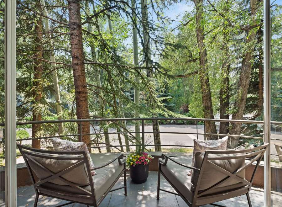 Enjoy serene moments on this charming balcony, offering a tranquil retreat amidst lush greenery.