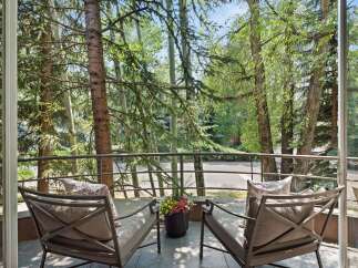 Enjoy serene moments on this charming balcony, offering a tranquil retreat amidst lush greenery.