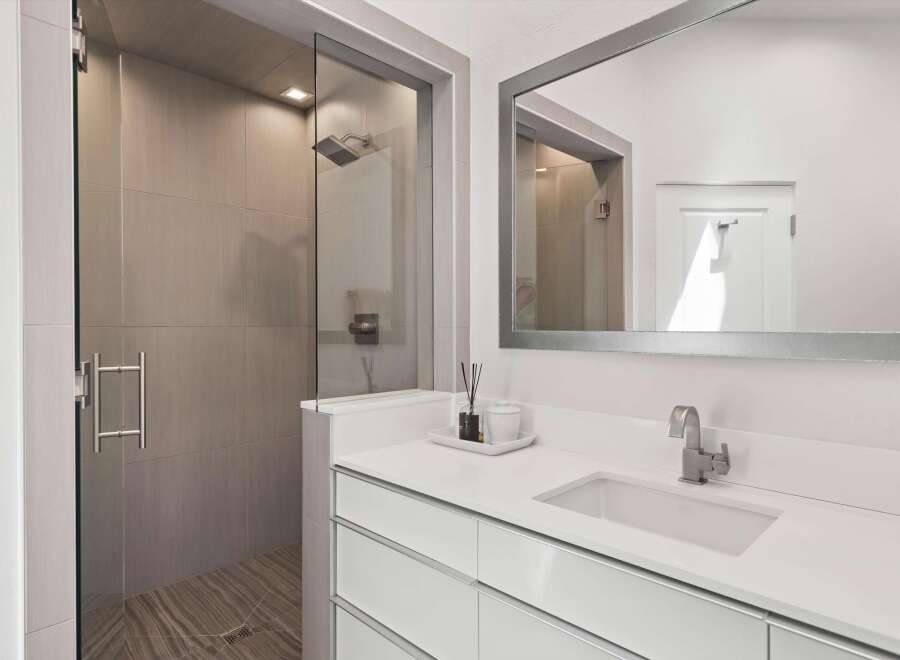 Experience modern luxury in this stunning bathroom featuring a spacious walk-in shower with elegant tilework and a sleek glass enclosure.