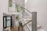 Experience modern living in this stunning home featuring a striking open-concept staircase with sleek cable railings.
