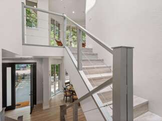 Experience modern living in this stunning home featuring a striking open-concept staircase with sleek cable railings.