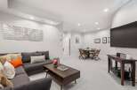 This spacious living area features a comfortable sectional sofa adorned with decorative pillows, perfect for relaxing.