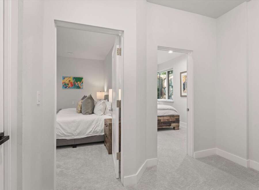 Step into a bright and airy hallway featuring two inviting bedrooms.