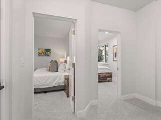 Step into a bright and airy hallway featuring two inviting bedrooms.